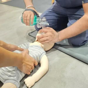 BLS CPR Class learning to perform life support on an infant
