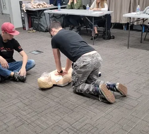 evolution-first-aid-35 Students performing compression CPR exercise in our hour-long, gamified class!
